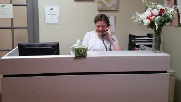 wf-academy-canada-student-books-appointments-at-spa lady at the reception answering the phone