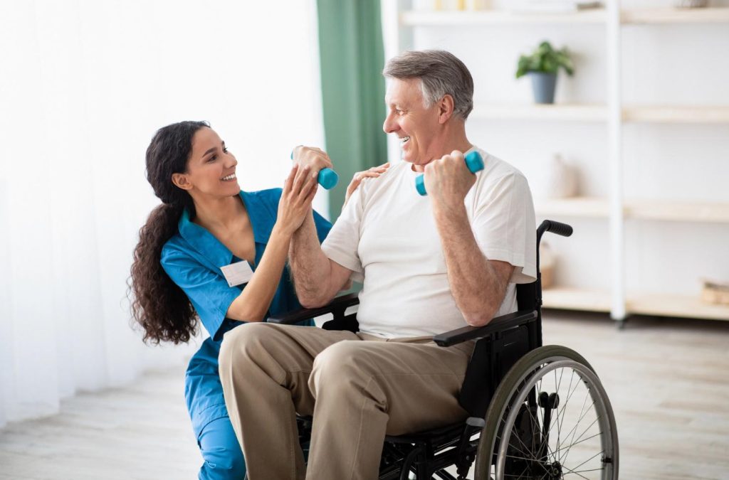 Young therapeutic recreation student in placement helping an elderly person