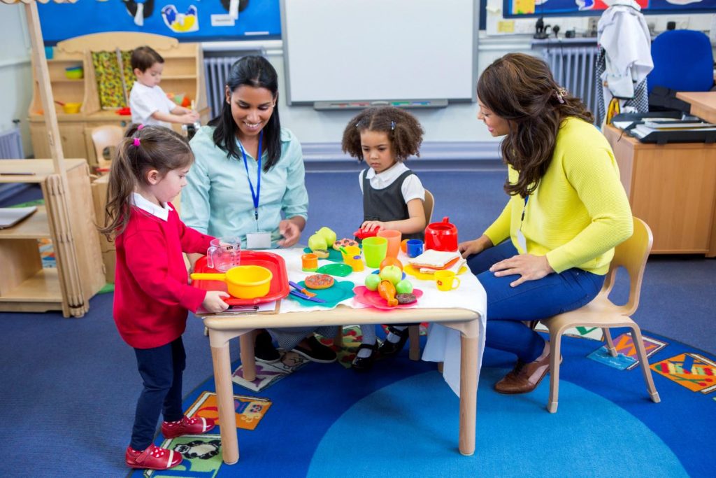 Childcare workers play with children