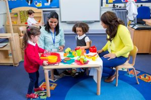 Childcare workers play with children