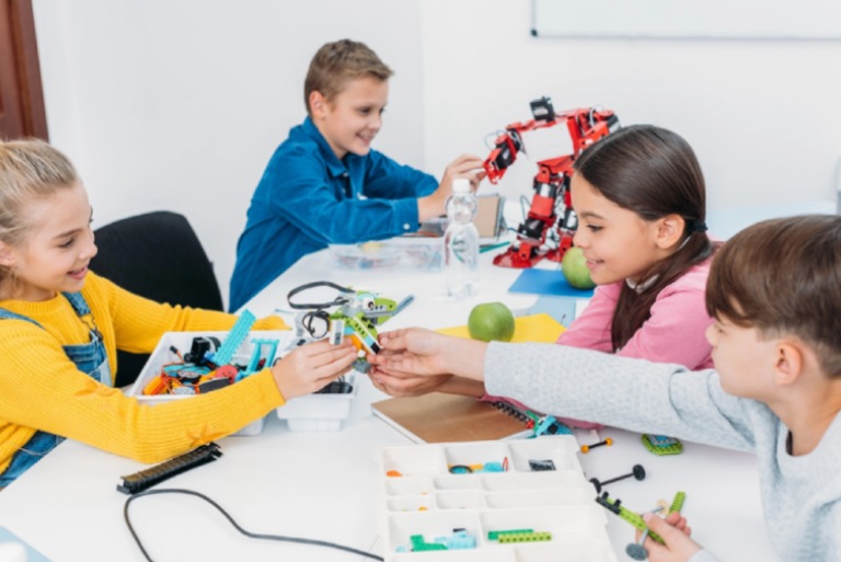 Four young children participating in an early learning classroom activity